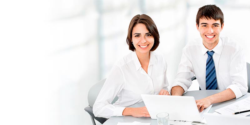 Hombre y mujer ejecutivos de oficina sonriendo mientras trabajan