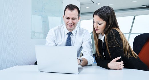 Dos ejecutivos en una reunión sobre la reglamentación de pago de impuestos