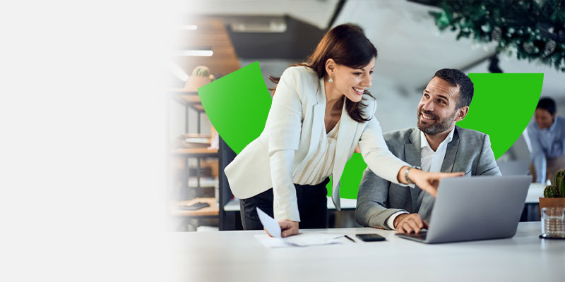 Una joven ejecutiva de camisa azul en su escritorio  consultando la información relevante